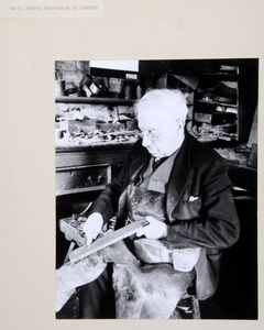Mr Tommy Hunter, boot-maker of Redmire, Wensleydale, sharpening a knife in his workshop. Image used for one of the photographic illustrations in 