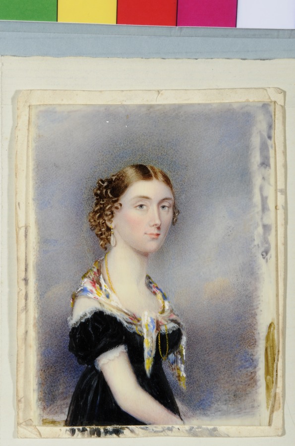 A young lady in a black dress, with coloured scarf